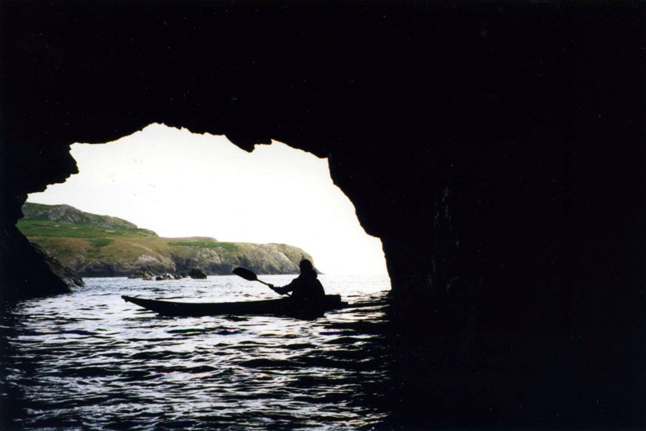 Sea kayaker in cave